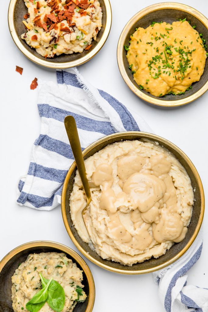 four bowls dairy free mashed potatoes on a table.