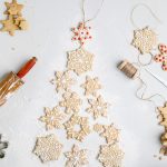 a batch of dairy free sugar cookies shaped like snowflakes.