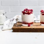 Homemade Dairy free coconut yogurt in a glass topped with raspberries.