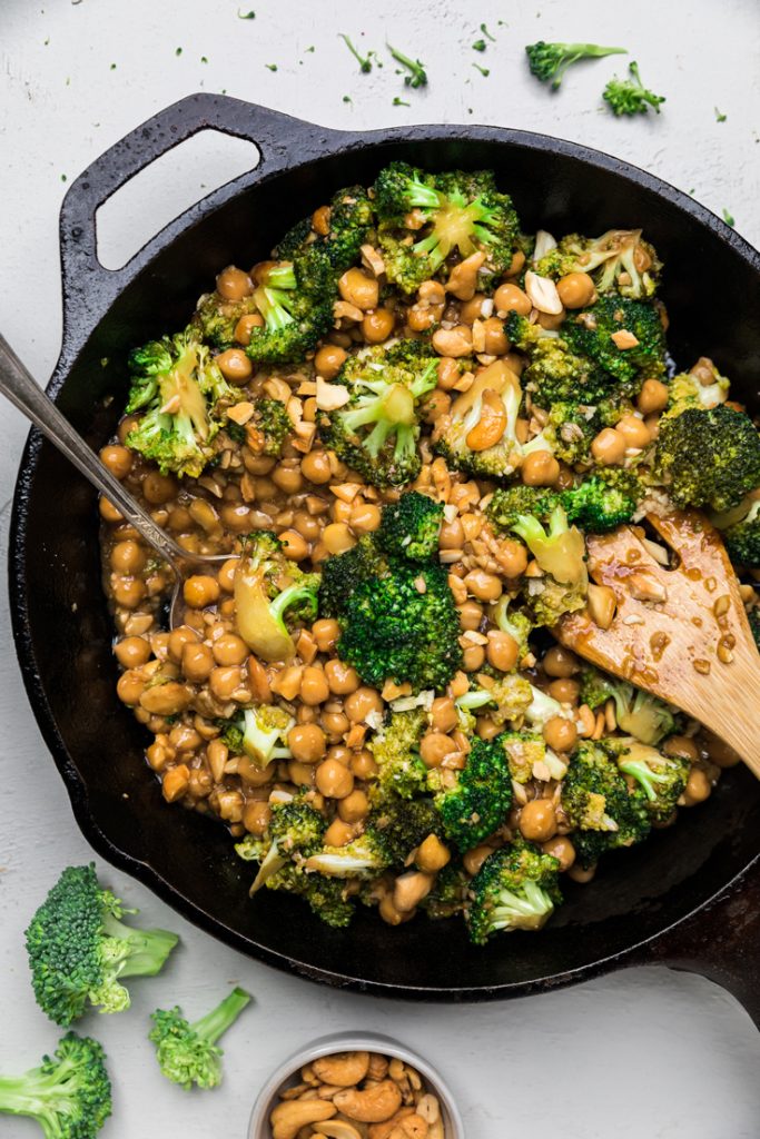 Chickpea, Cashew & Broccoli with Garlic Sauce Skillet with a spoon.