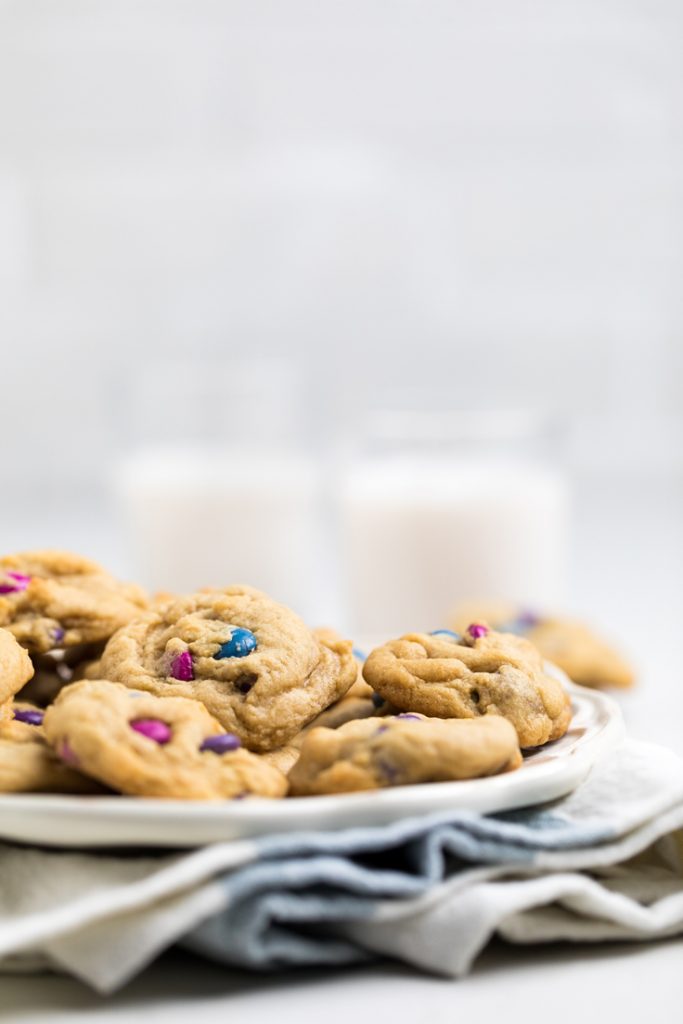vegan m and m cookies with blue and pink candies on a plate.