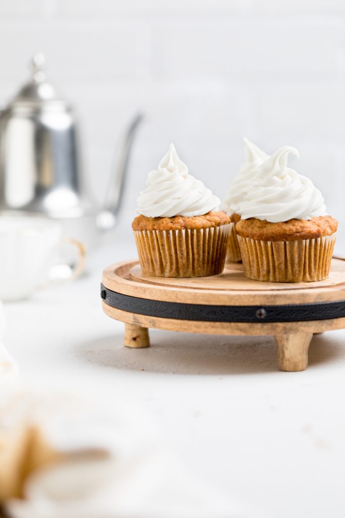 Dairy free carrot cake cupcakes on a cake stand.