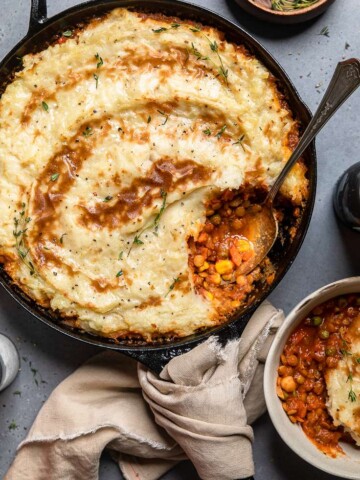 A skillet of Vegan Shepards pie with a spoon.
