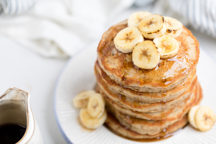 A stack of fluffy Vegan banana pancakes on a plate.