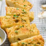 slices of vegan garlic bread topped with fresh herbs.