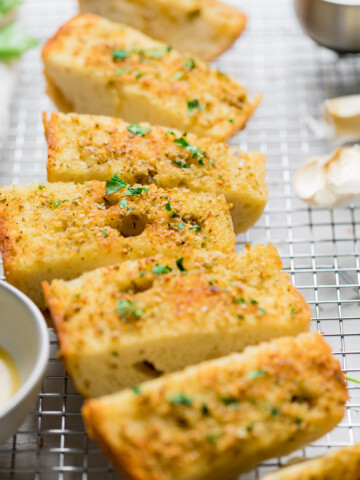 slices of vegan garlic bread topped with fresh herbs.