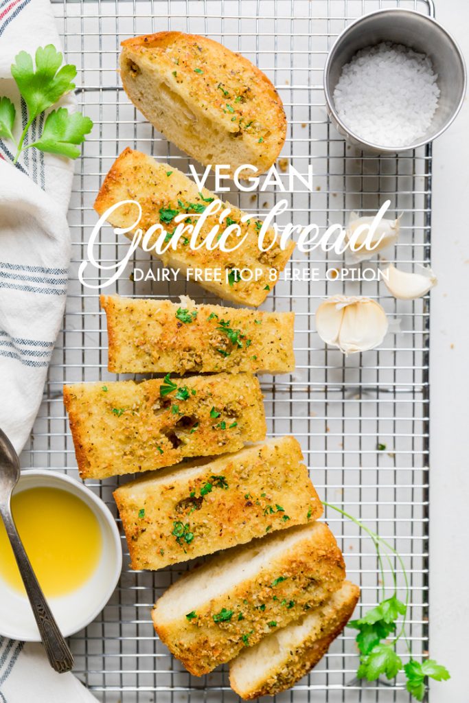 the words vegan garlic bread overlayed onto a loaf of bread.