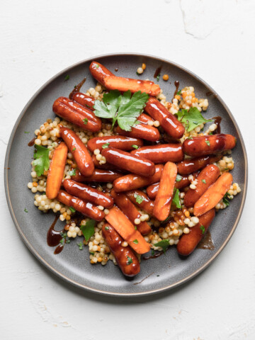 a plate of vegan glazed carrots over quinoa.