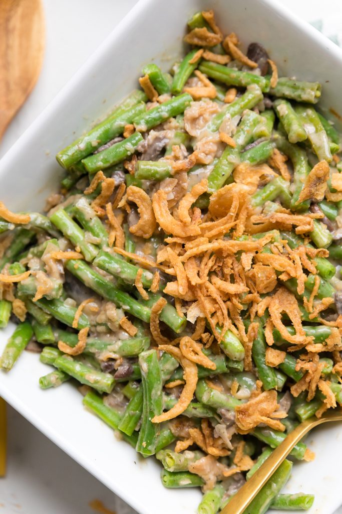 Cooked vegan green bean casserole topped with fried onions.