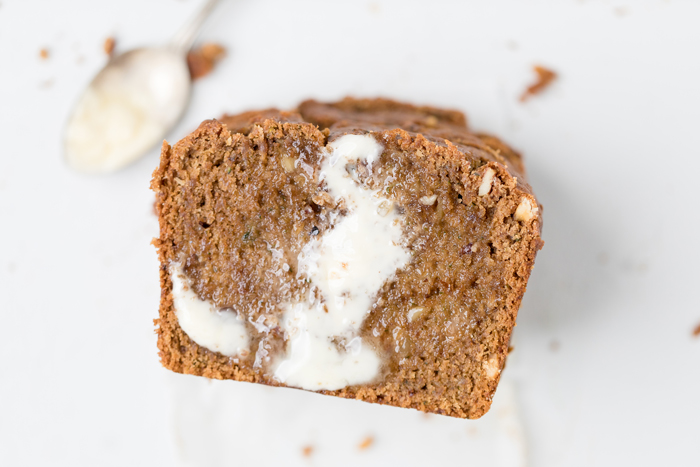 A slice of vegan zucchini bread with butter.