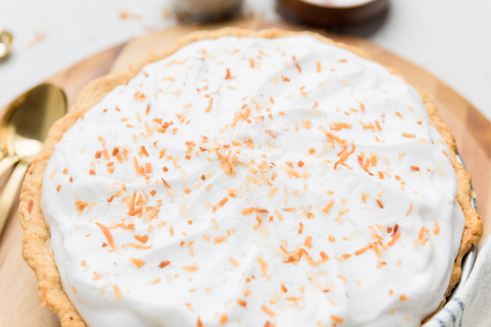 top of a vegan coconut cream pie topped with toasted coconut flakes.
