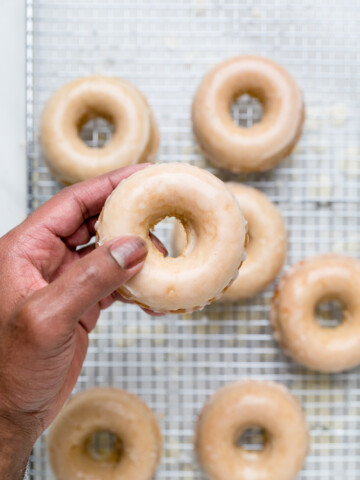 A single glazed vegan donut in a hand.