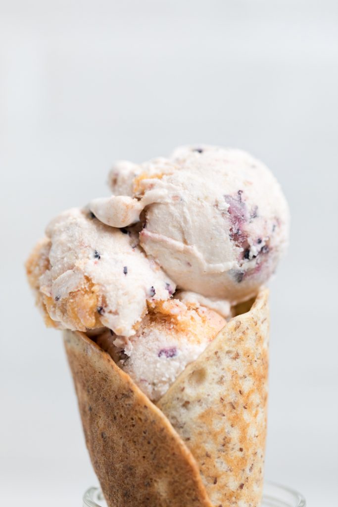 three scoops of vegan vanilla blueberry peach ice cream.