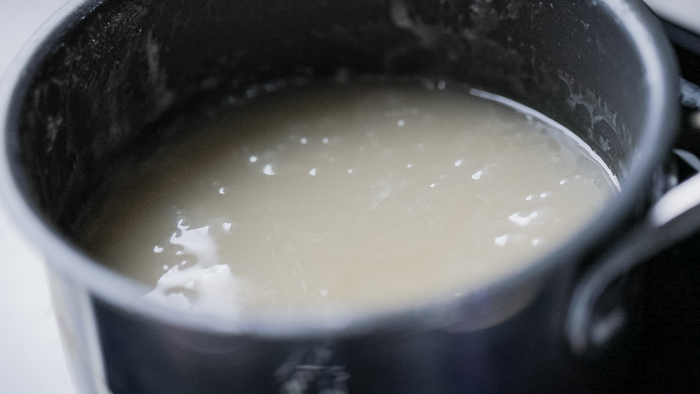 vegan condensed milk cooking in a pot.