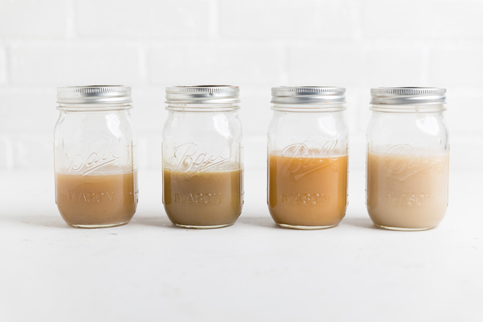 four mason jars filled with vegan condensed milk.