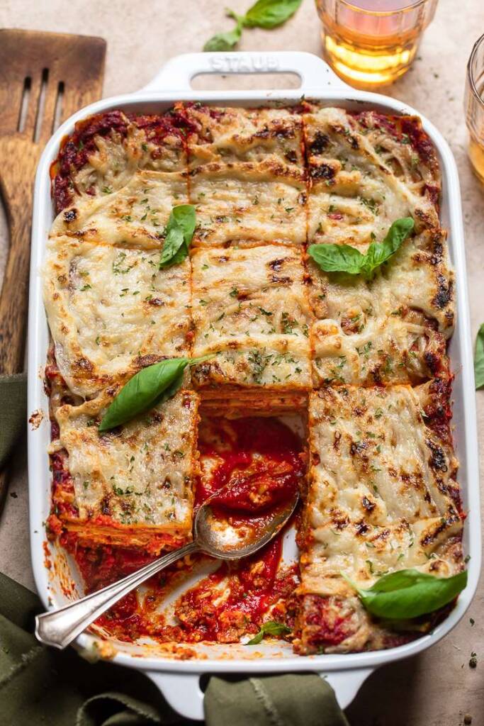 vegan lasagna cut with pieces missing.