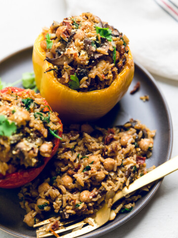 a plate of tuscan style vegan stuffed peppers.