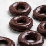 A batch of vegan chocolate donuts.