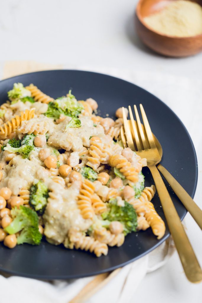 a plate of creamy pasta with broccoli and chickpeas.