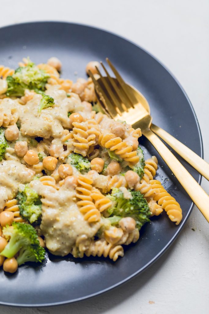 a plate of cooked vegan creamy broccoli and chickpea pasta.