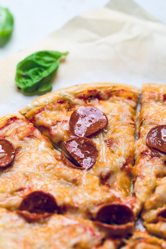 A slice of vegan pepperoni pizza.