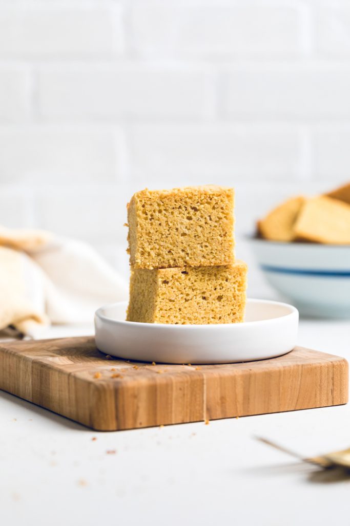 two slices of vegan cornbread stacked onto a plate.