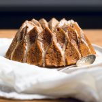 A cooked Vegan Pumpkin Bundt Cake with drizzle.