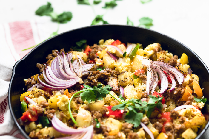 Vegan breakfast skillet with red onions and cilantro on top.
