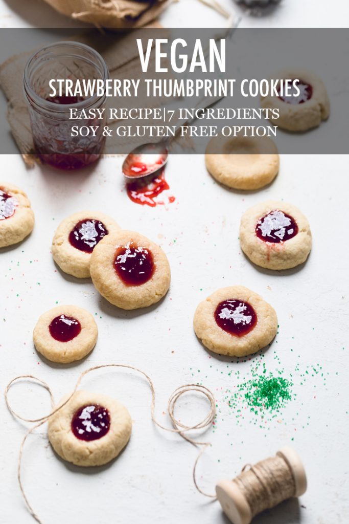 the words strawberry thumbprint cookies overlayed onto a batch of cookies.
