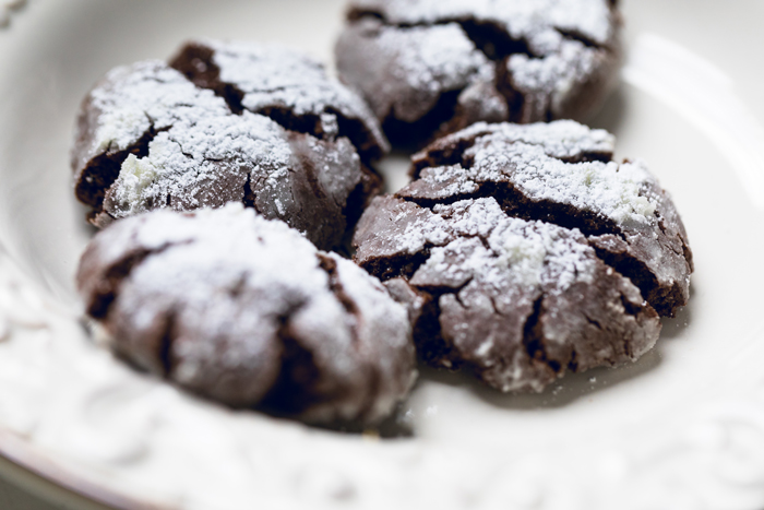 Vegan chocolate crinkle cookies topped with extra powdered sugar. 