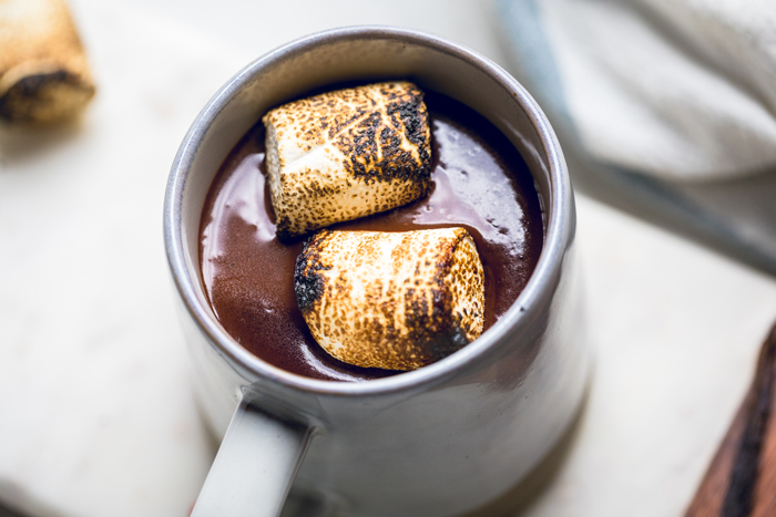 Toasted vegan marshmallows on top of thick vegan Neapolitan hot chocolate.