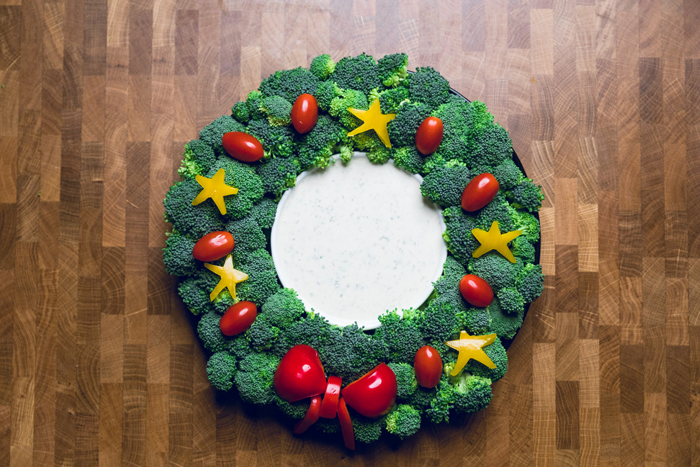 Vegan Christmas Veggie Wreath with a bowl of vegan ranch in the center.