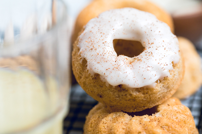 A vegan eggnog donut with glaze and cinnamon.