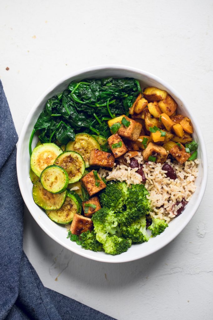 Vegan jerk tofu rice bowls with vegetables.