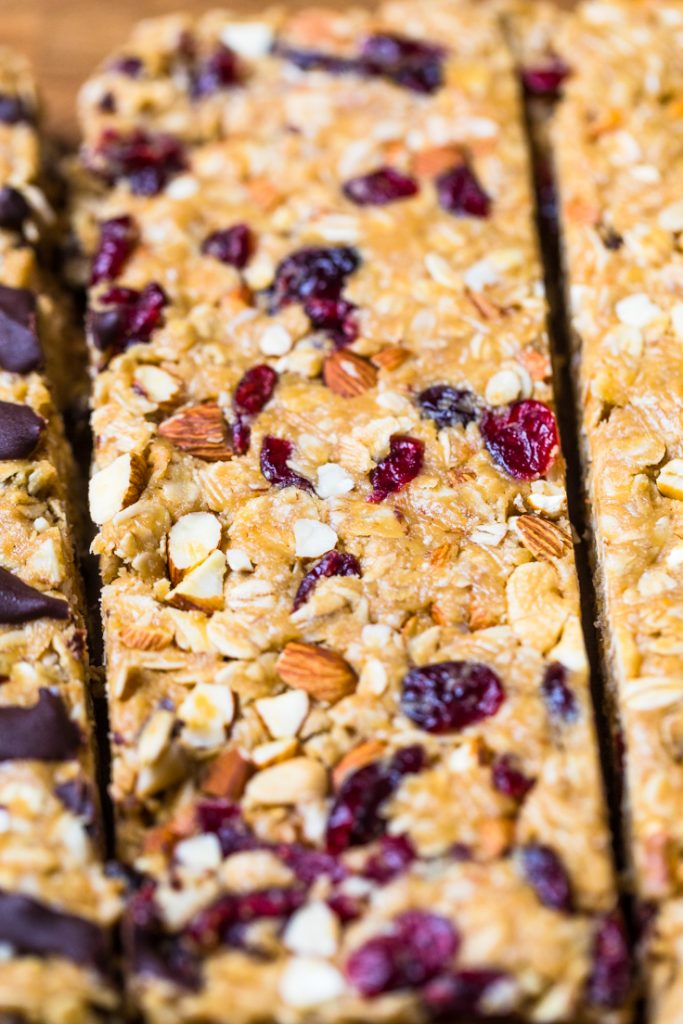 A homemade vegan granola bar with dried cranberries and almonds.