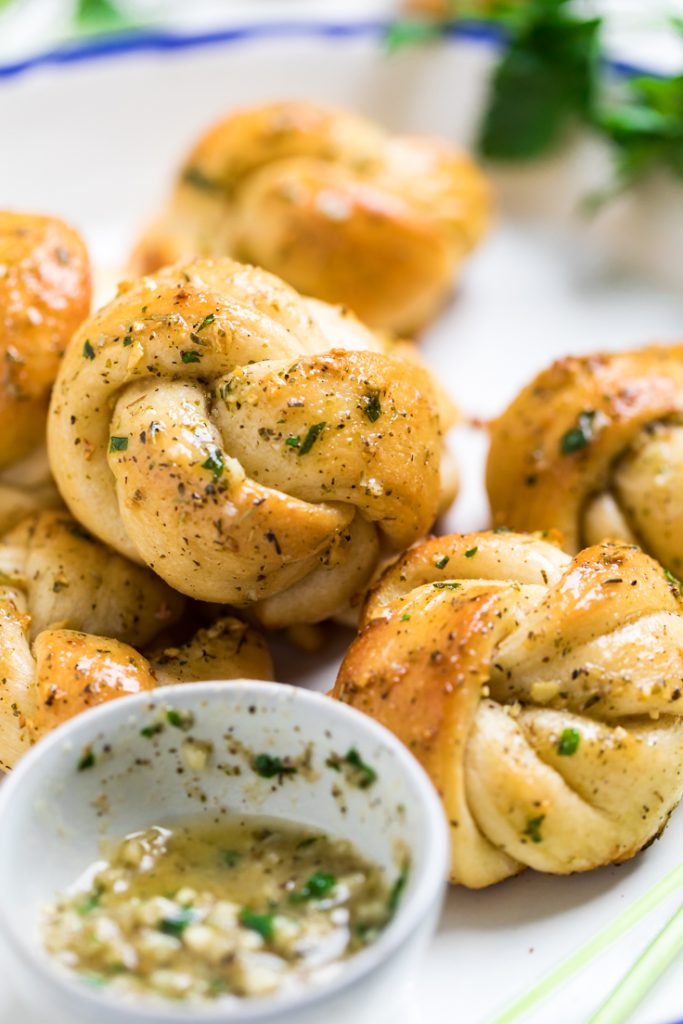 A vegan garlic knot brushed with herb butter.