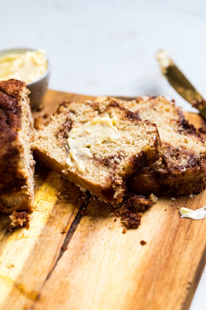Two slices of vegan cinnamon quick bread with butter.