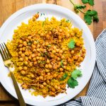 A plate of spicy coconut chickpeas with golden turmeric rice.