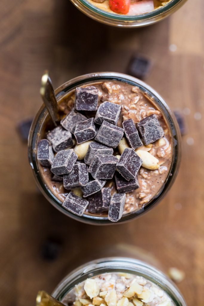 Chocolate chunks and peanuts over vegan chocolate peanut butter overnight oats.