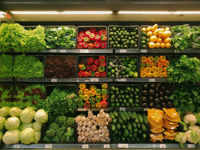 A grocery store aisle with produce.