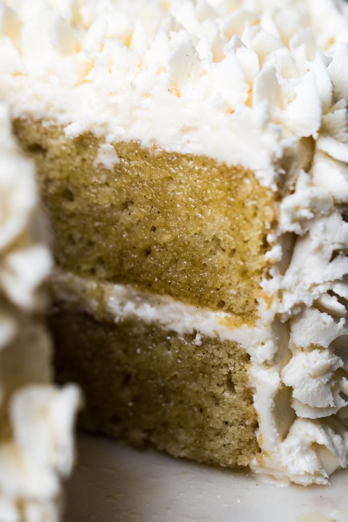 Slice of vegan vanilla cake with fluffy textures.