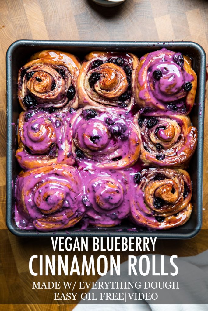 The words vegan blueberry cinnamon rolls overlayed onto a tray of them.
