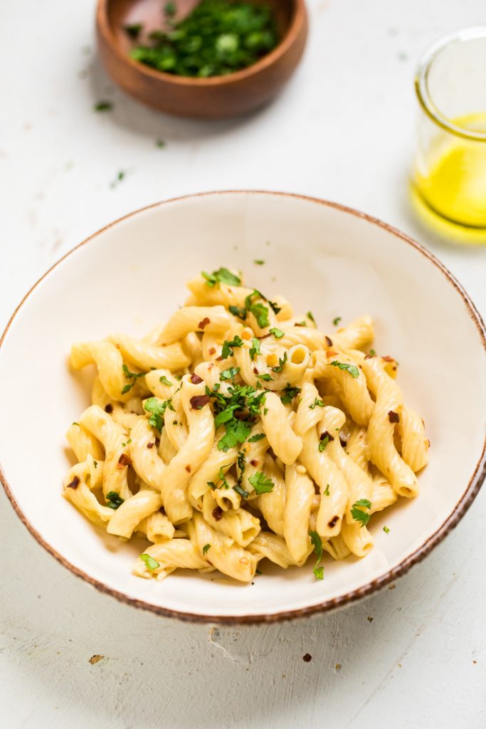 10 minute spicy vegan garlic and oil pasta in a bowl with fresh parsley.