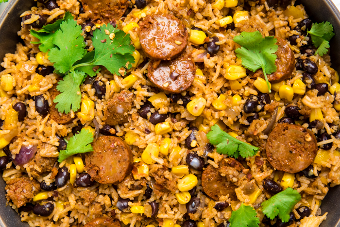 Vegan chorizo fried rice with black beans and corn topped with cilantro.