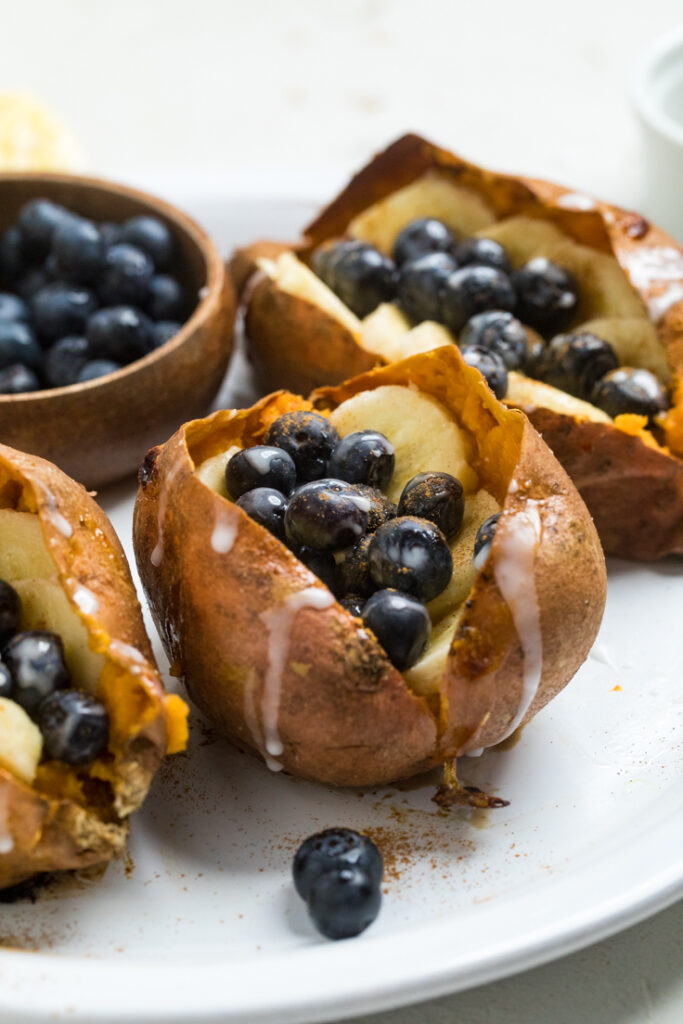 Banana and Blueberry Stuffed Sweet Potatoes with glaze drizzle.