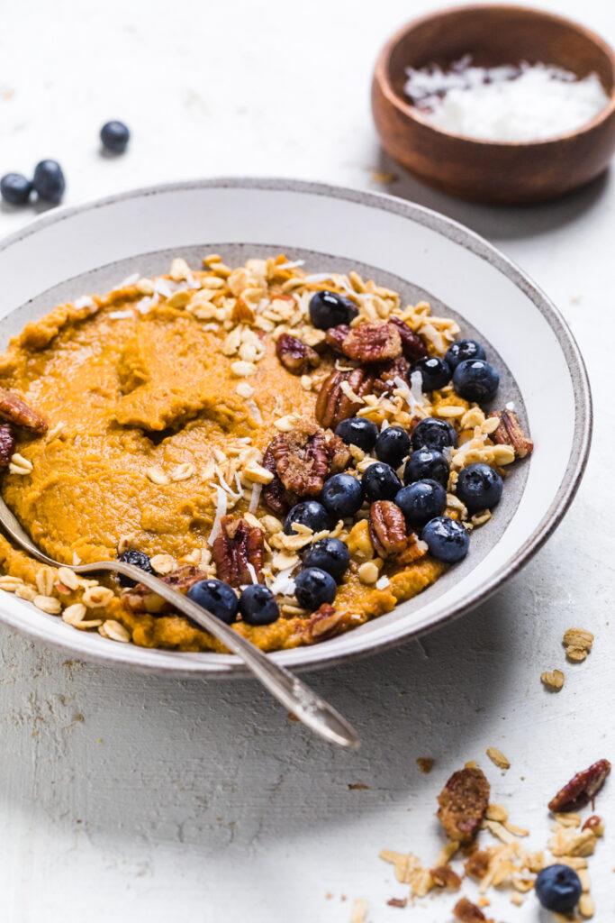 Easy breakfast vegan sweet potato bowl with blueberries and granola.