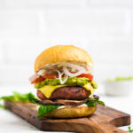 A vegan high protein burger on a board.