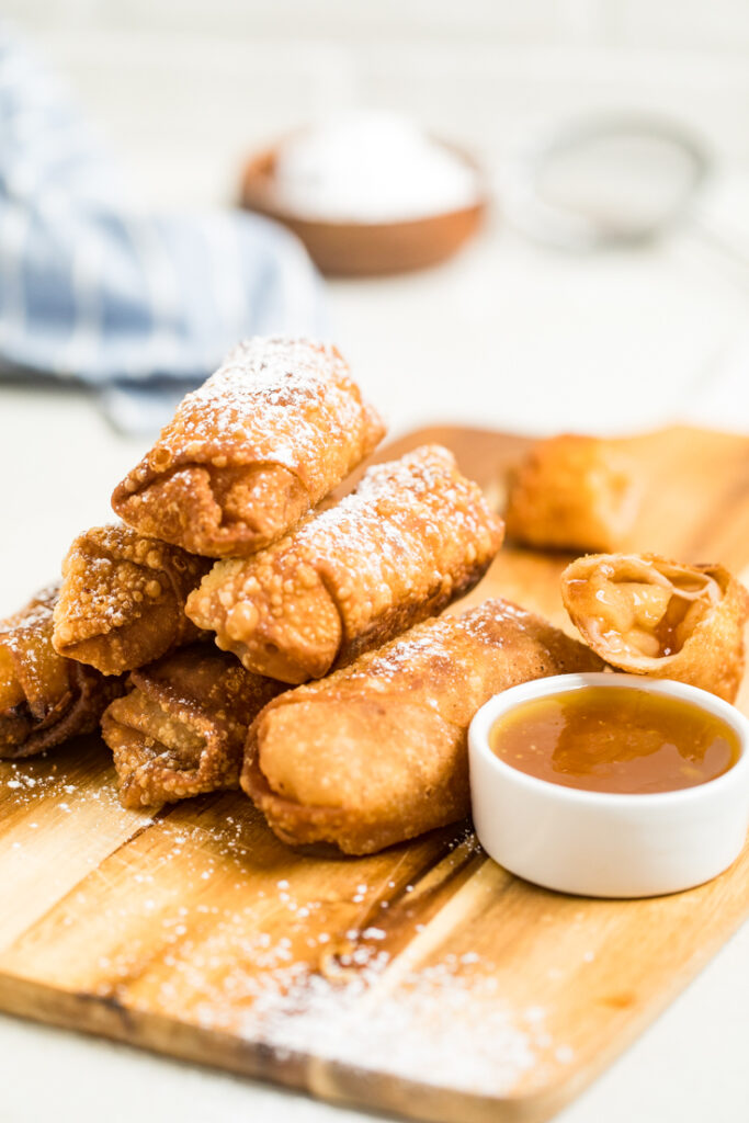 Two ingredient vegan apple pie egg rolls in stacked in a triangle.