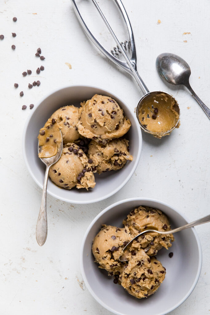 Two bowls of vegan edible cookie dough with spoons.