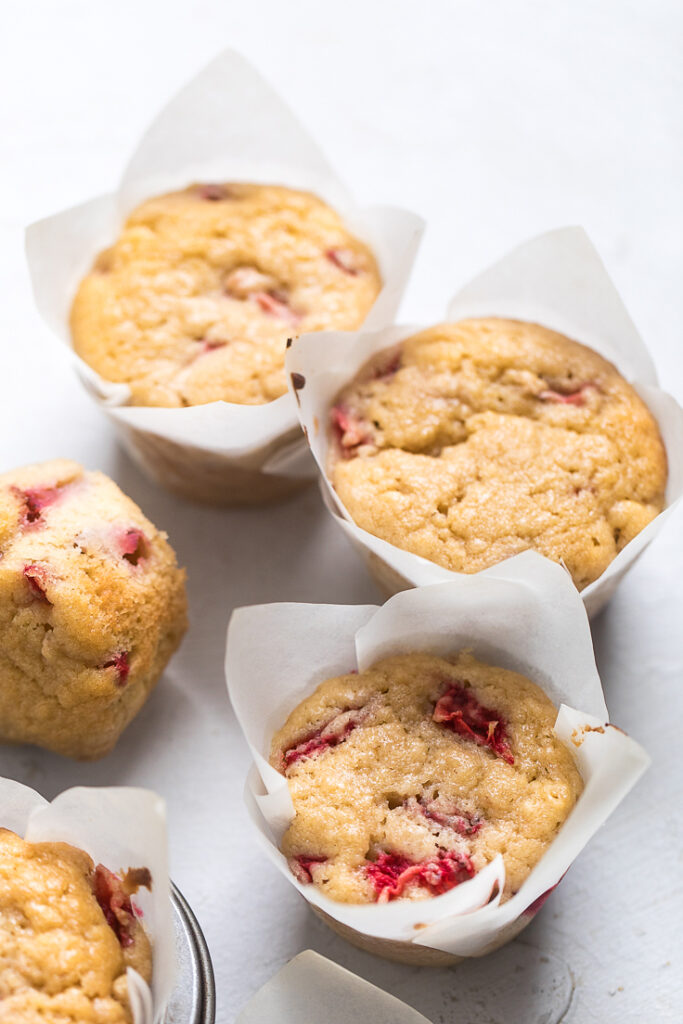 Vegan strawberry muffins in white muffin liners.